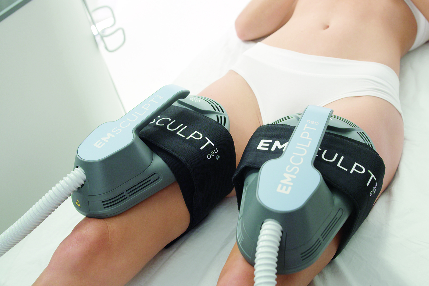 Female patient receiving EMSCULPT NEO® Treatment on her quads 