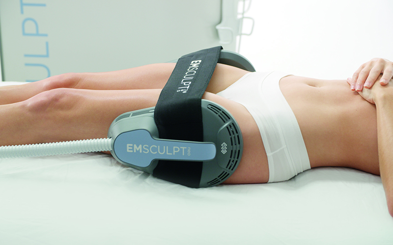 Side view photo of a female patient with EMSCULPT NEO® around her thighs